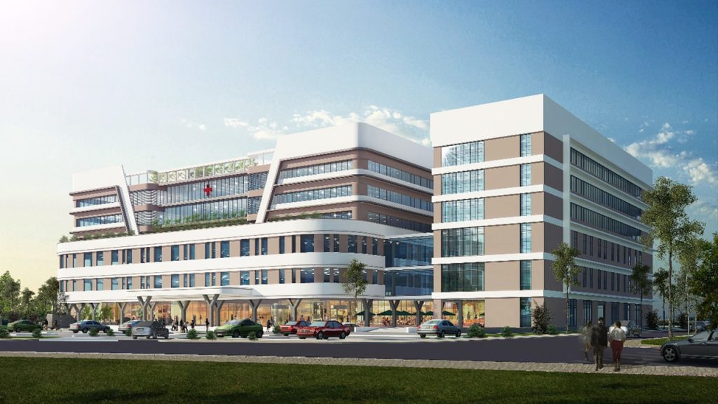 Alluvia City Văn Giang 30 Hình ảnh phối cảnh bệnh viện đa khoa hiện đại tại Alluvia City, với tòa nhà cao tầng thiết kế khối vuông vức, mặt kính rộng, khuôn viên xanh và bãi đỗ xe phía trước.